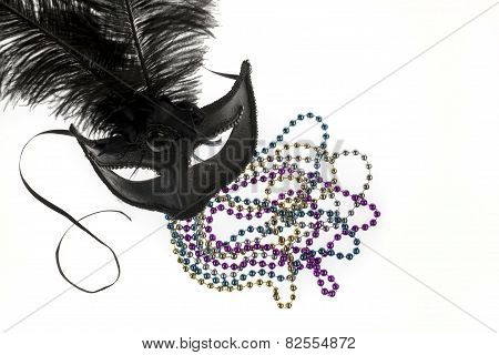 Shiny Gold, Purple, Blue And Silver Beads And Mardi Gras Mask With Feathers On A White Background. S