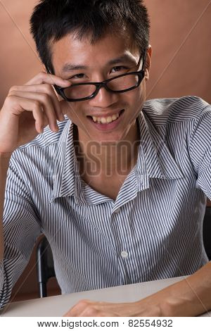 Successful business man of Chinese sitting, closeup portrait in studio.