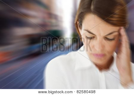 Woman with headache against blurry new york street