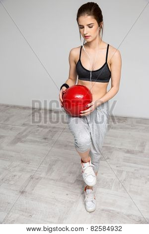 Sports woman working out with a medicine ball