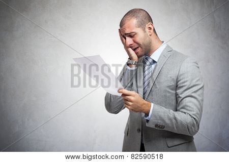 Depressed man reading a document