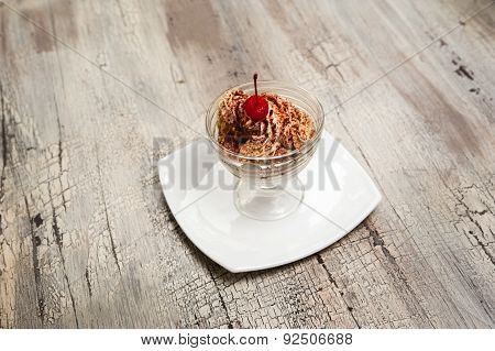 Ice Cream With Chocolate Crumb And Cherry In Glass Bowl