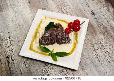 Juicy Grilled Beef Steak And Mushrooms With Tomatoes And Leafs