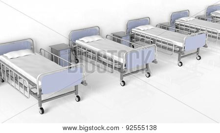 Hospital beds and bedside tables in a row
