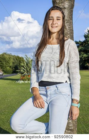 Beautiful Teenager Leaning On A Tree