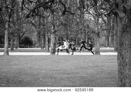 Black And White Image Of A Group Of Children Running In A Park