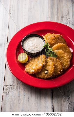 tasty sabudana vada or sabudana vade made up of Sago served with peanut chutney, a famous fasting recipe or snack from maharashtra, India