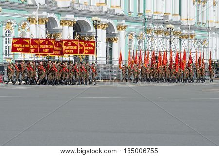 SAINT PETERSBURG, RUSSIA - MAY 05, 2015: The group of soldiers with banners of the Great Patriotic War. Rehearsal of parade in honor of Victory Day on Palace Square. St. Petersburg