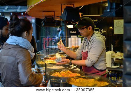 LONDON - OCTOBER 04: Unidentified people trade food in Camden Town market on October 04 2014 in London UK. Camden Town markets are visited by 100000 people each weekend