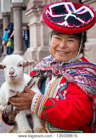 Cuzco Peru - March 18 2015: Peruvian woman in traditional dresses pose for tourists in Cuzco Peru: Peruvian woman in traditional dresses pose for tourists in Cuzco Peru
