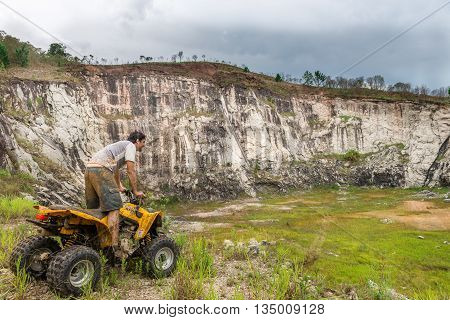 Off Road On Quad Bike Rally Over Mud Puddle