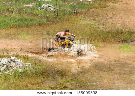 Off Road On 4X4 Quad Bike Through Mud Puddle