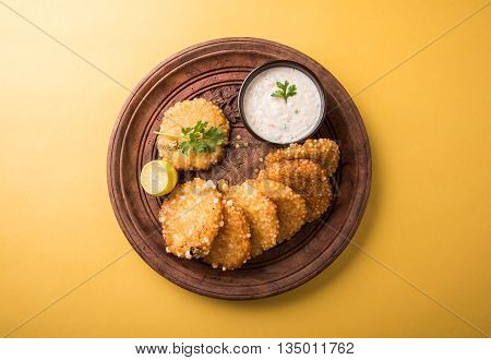 tasty sabudana vada or sabudana vade made up of Sago served with peanut chutney, a famous fasting recipe or snack from maharashtra, India