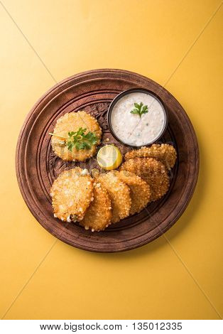 tasty sabudana vada or sabudana vade made up of Sago served with peanut chutney, a famous fasting recipe or snack from maharashtra, India