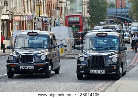 LONDON - OCTOBER 03: London Taxi on October 03 2014 in London UK. Traditionally Taxi cabs are all black in London but now produced in various colors.