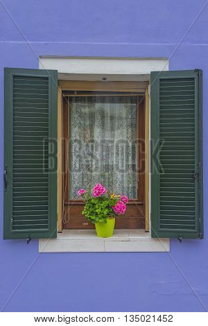 Traditional Venetian Wondow With Flowers In The Pot