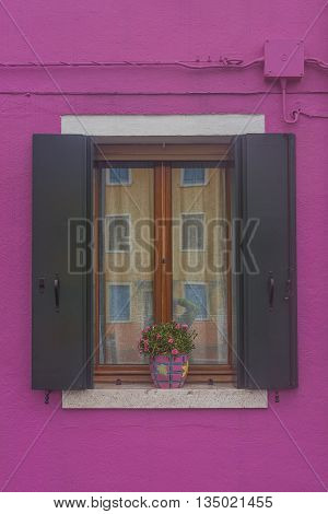 Traditional Venetian Wondow With Flowers In The Pot