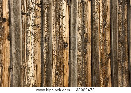 Wood boards on historical barn with golden tones.
