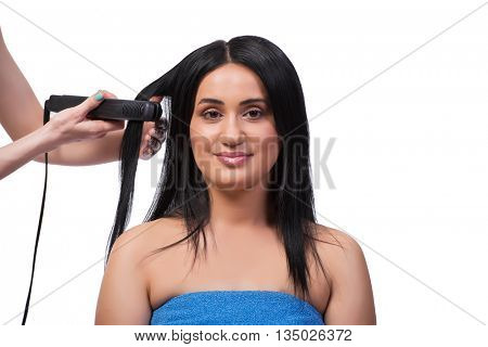 Young woman getting hair straightner isolated on white