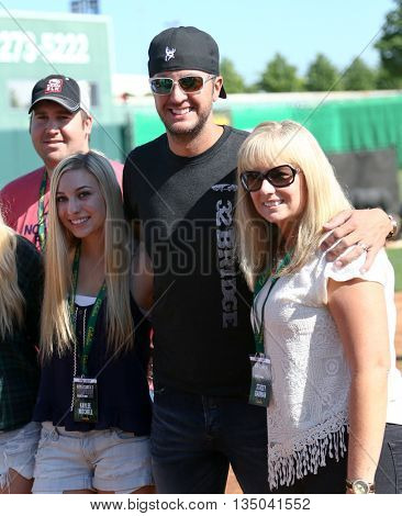 ARLINGTON, TX - APR 18: Luke Bryan (C) poses with fans at the ACM & Cabela's Great Outdoor Archery Event at the Texas Rangers Youth Ballpark on April 18, 2015.