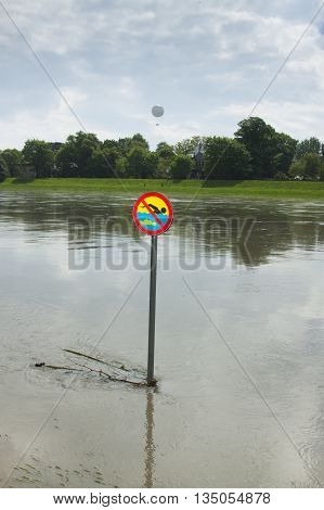 Poland Kraków flooded Vistula/Wisła river embankments no swimming sign over the water sightseeing baloon in the background
