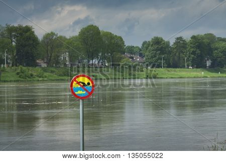 Polnad Kraków flooded Vistula/Wisła river embankments no swimming sign over the water