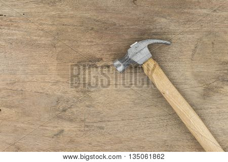 Small Hammer on wood background panel wooden