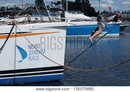 ST. PETERSBURG, RUSSIA - JUNE 4, 2016: Unidentified German athlete prepares the yacht SGM to the Nord Stream Race. Five teams on the Swan 60 yachts compete in the race this year