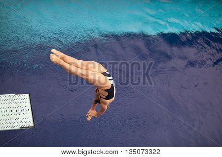 High Diver. Girl Diving Into The Pool