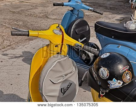 FORLIMPOPOLI FC ITALY - JUNE 19: yellow classic scooter Vespa with spare wheel cover parked during the italian scooter rally 