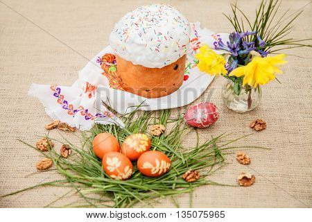 Homemade Easter cake and painted eggs on the table