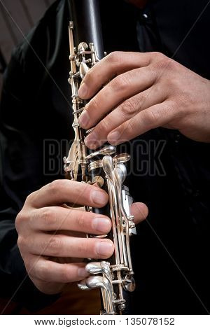 hands of a clarinet player in black