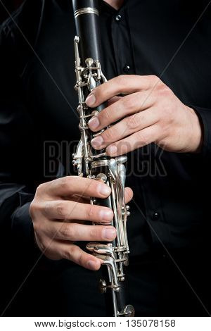 hands of a clarinet player in black