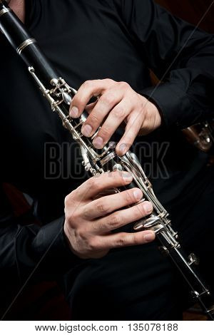 hands of a clarinet player in black