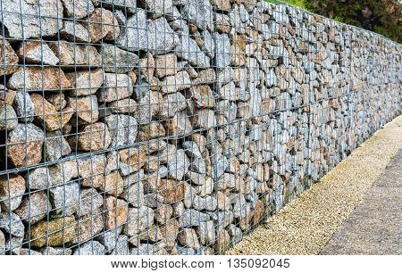 Wire Gabion Rock Fence. Metal Cage Filled With Rocks.