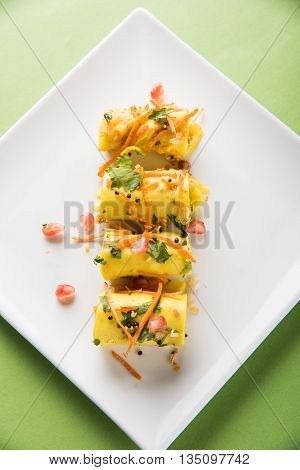 khandvi is a gujarati snack from India which is made with gram flour and curds tempered with sesame seeds and mustard seeds also known as Surali chya Vadya/Stuffed Khandvi, selective focus