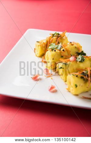 khandvi is a gujarati snack from India which is made with gram flour and curds tempered with sesame seeds and mustard seeds also known as Surali chya Vadya/Stuffed Khandvi, selective focus