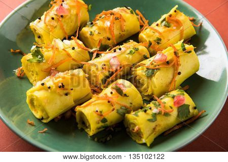 khandvi is a gujarati snack from India which is made with gram flour and curds tempered with sesame seeds and mustard seeds also known as Surali chya Vadya/Stuffed Khandvi, selective focus