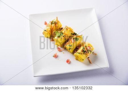 khandvi is a gujarati snack from India which is made with gram flour and curds tempered with sesame seeds and mustard seeds also known as Surali chya Vadya/Stuffed Khandvi, selective focus