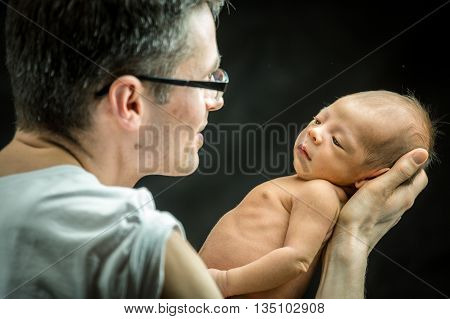 Happy Father Holding With Love His New Born Son
