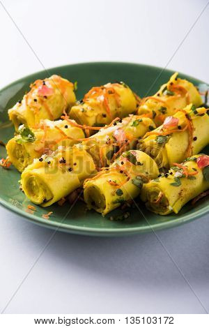 khandvi is a gujarati snack from India which is made with gram flour and curds tempered with sesame seeds and mustard seeds also known as Surali chya Vadya/Stuffed Khandvi, selective focus