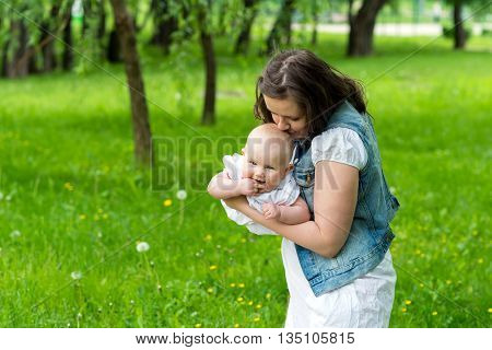 young woman and her cute baby girl outdoor