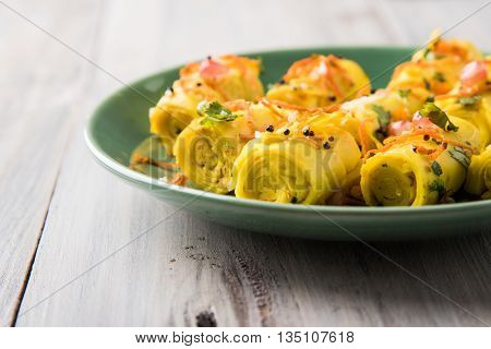 khandvi is a gujarati snack from India which is made with gram flour and curds tempered with sesame seeds and mustard seeds also known as Surali chya Vadya/Stuffed Khandvi, selective focus