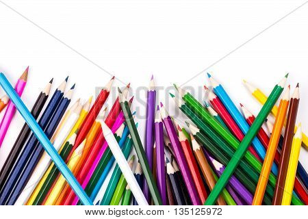 Color pencils topsy-turvy pile on white background