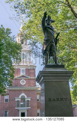 Independence Hall in Philadelphia Pennsylvania with Commodore Barry statue in foreground.