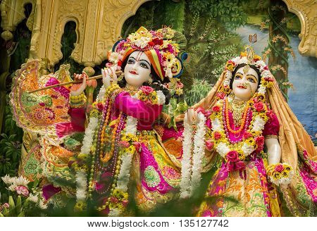 Durban, South Africa - March 20, 2016: Hindu God Krishna with his wife Radha. Bright colorful sculptural composition. Artistic retouching.