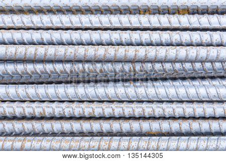 The deform barthe deform bar pile on the construction site.The steel bar pile with the rusty.Close up of the steel bar with the rusty in the construction site.The corrosion on the steel bar.