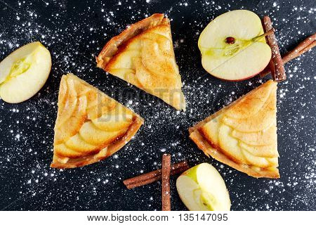 Slice of Golden Bramley apple tart with cinnamon glaze.