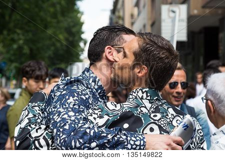 MILAN ITALY - JUNE 18: Fashionable people gather outside Marni fashion show building for Milan Men's Fashion Week on JUNE 18 2016 in Milan.