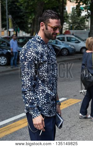 MILAN ITALY - JUNE 18: Fashionable man poses outside Marni fashion show building for Milan Men's Fashion Week on JUNE 18 2016 in Milan.